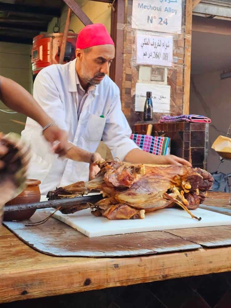 A roasted sheep being carved 