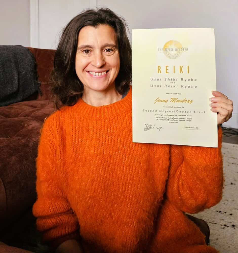 Jenny Mowbray holding Reiki certificate from the Reiki Academy 