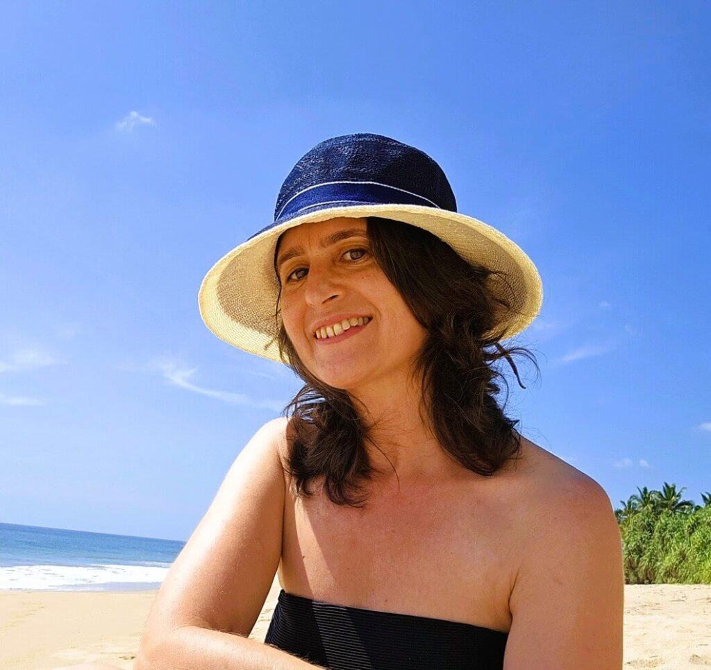 A photo of myself on the beach in a sunhat 