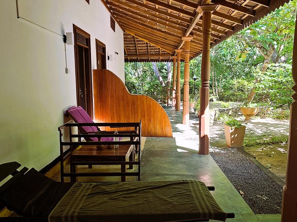 A terrace with reclining chairs at Nature Lanka Resort