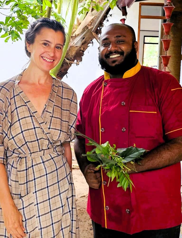 Myself and the chef holding leaves at Nature Lanka Ayurvedic Resort