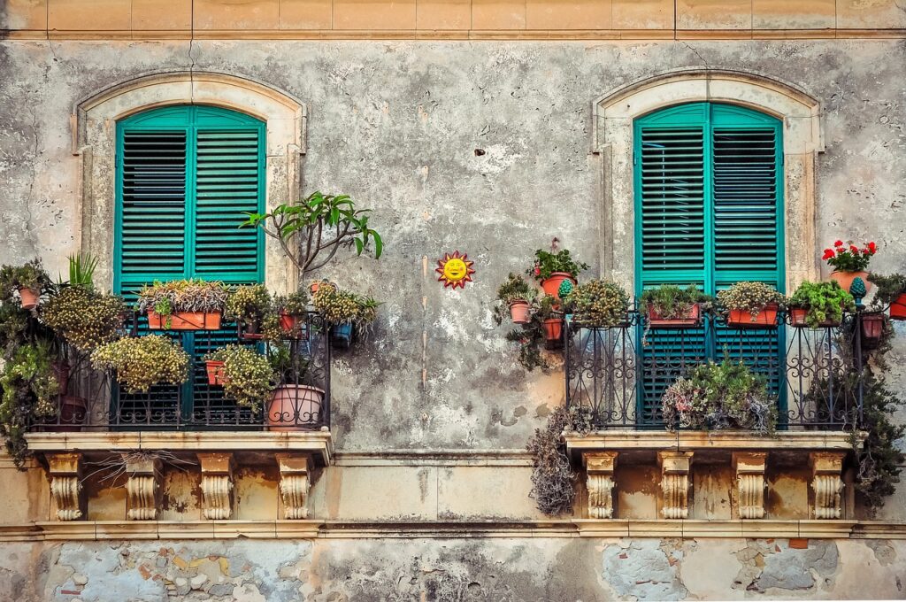 Image of balconies with flowers - could be France 