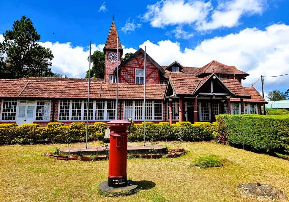 A red bricked building - Victorian style and a red English letterbox 