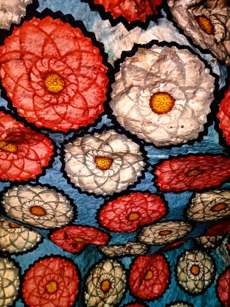 bright pink and white lotus flowers decorate a rock temple roof