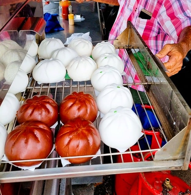 brown and white steamed buns on a rack 