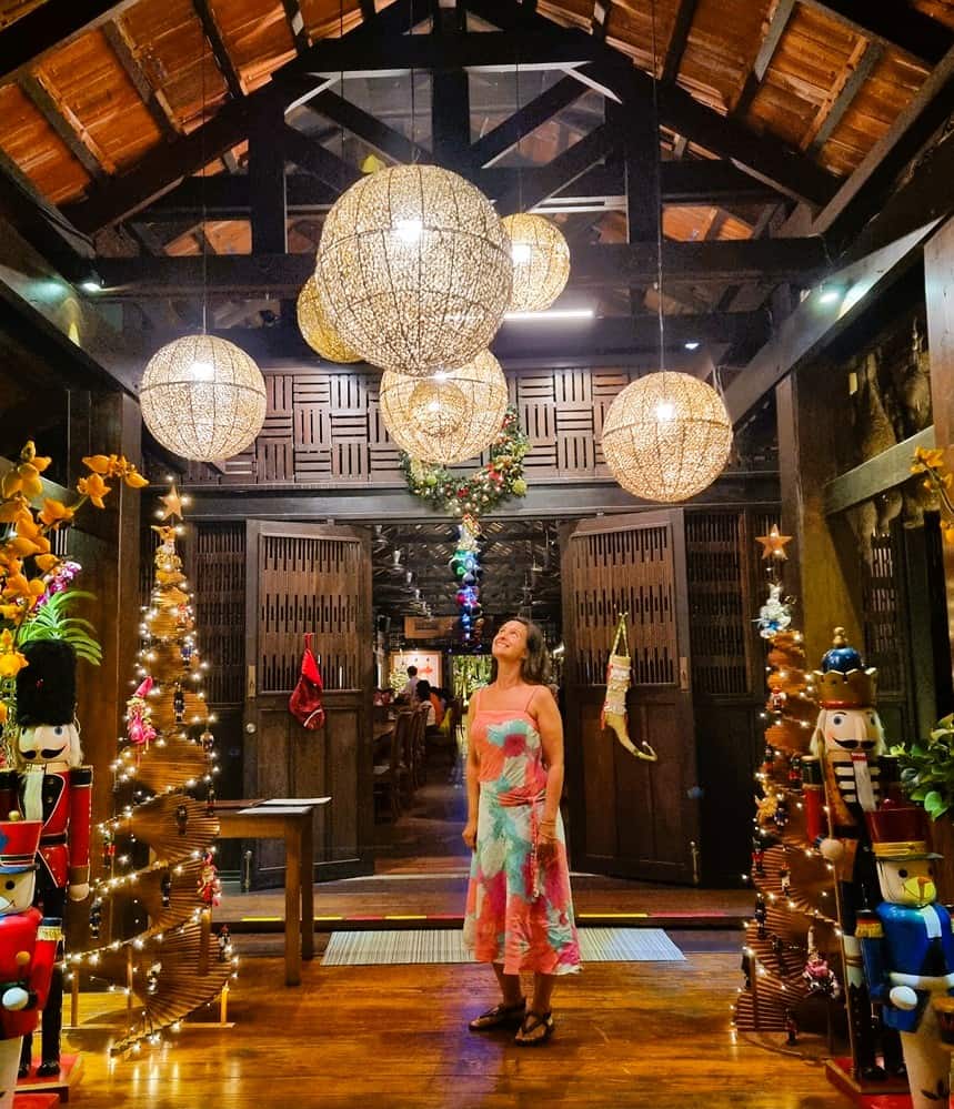 Myself, Jenny surrounded by Christmas decorations - looking up to some lanterns happily
