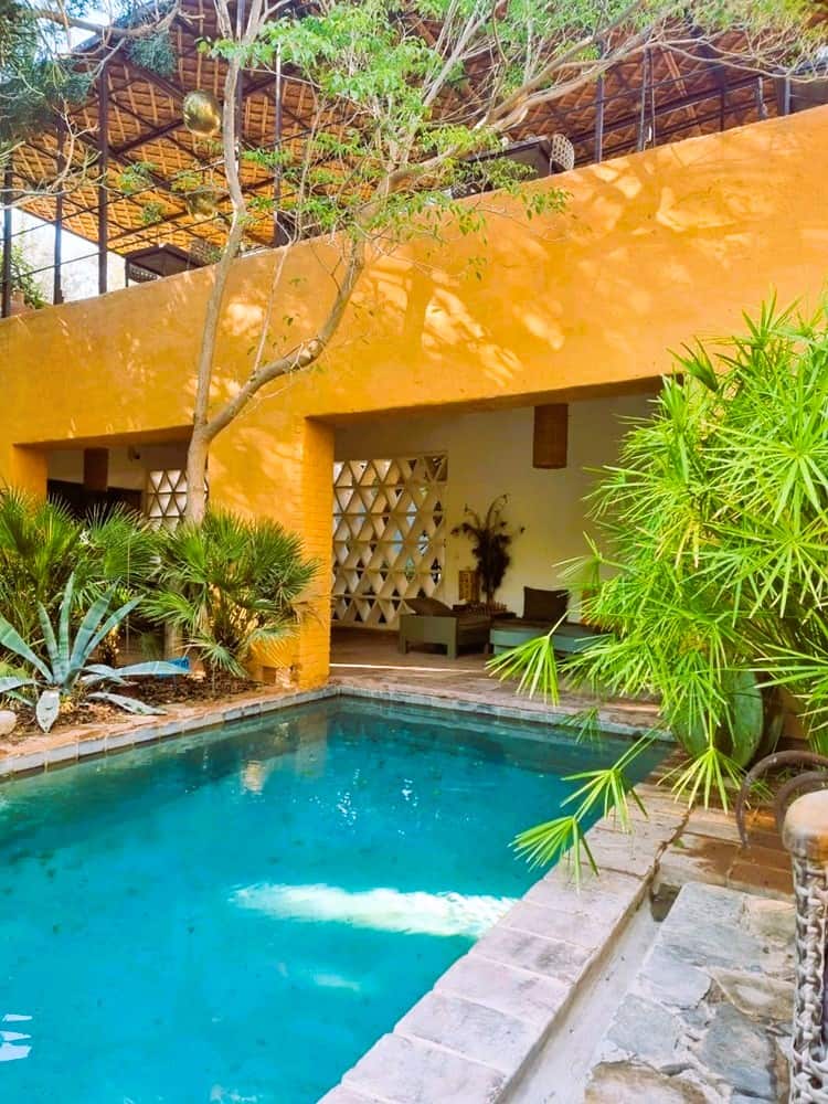 an image of the swimming pool next to a yellow building at Dar Al Hussoun: Taroudant