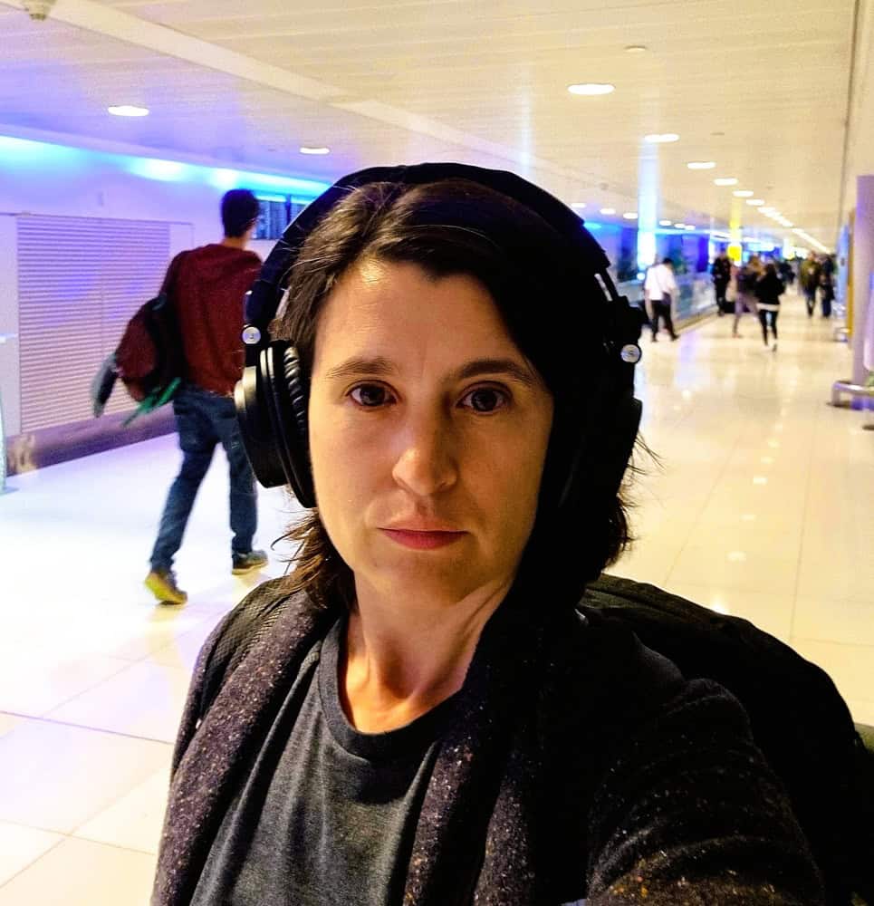 Myself with my headphones at an KL airport - my first adventure with chronic illness and post breakup 