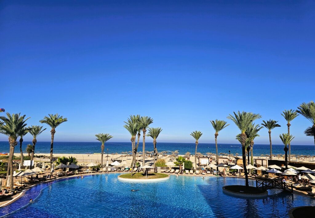 a view of the ocean and pool at Mövenpick Resort & Marine Spa 