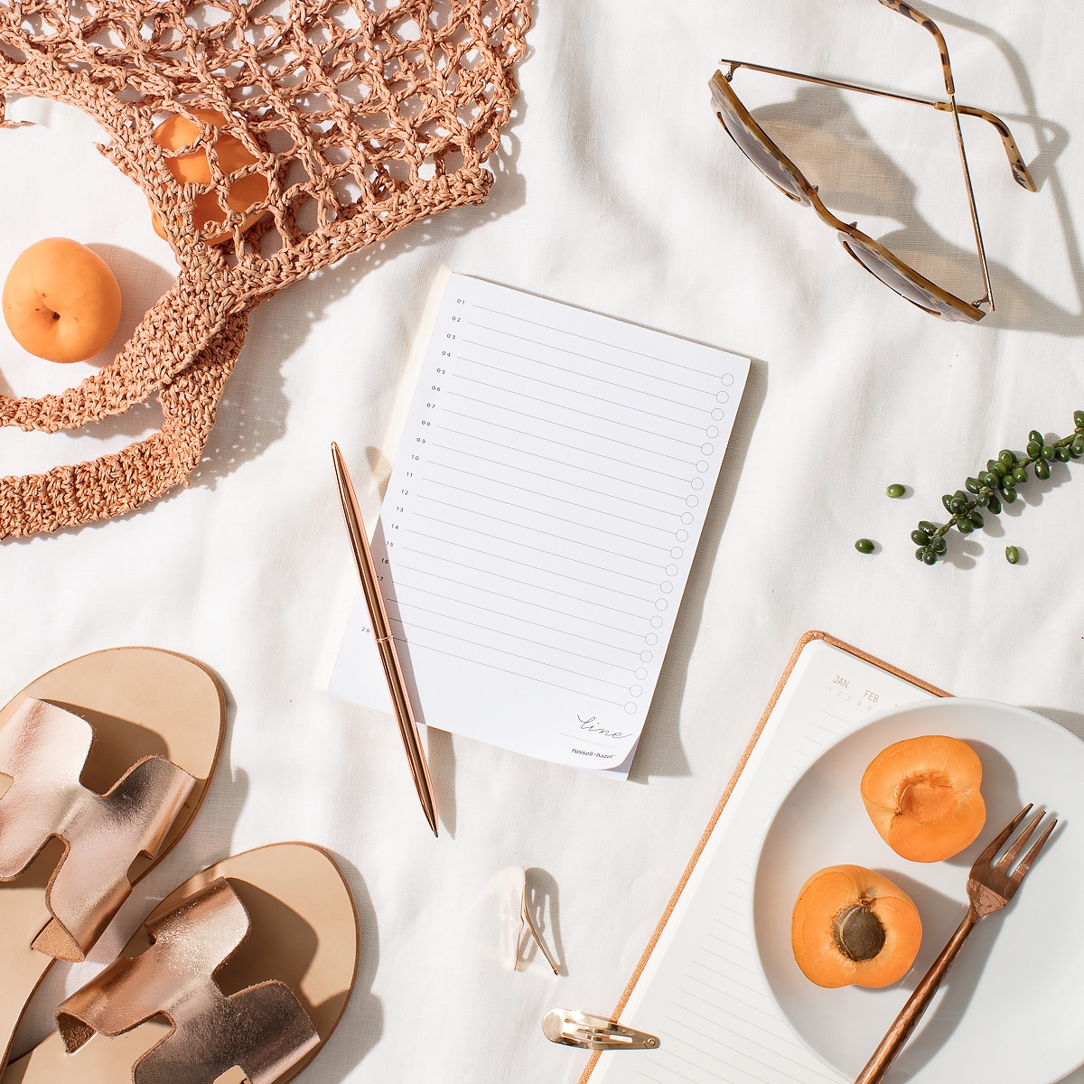 an image of notebook, sunglasses and other holiday items 