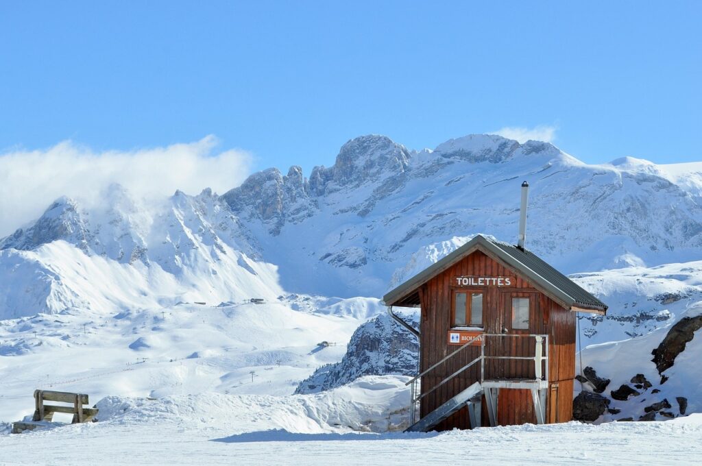 an toilet in the middle of mountains