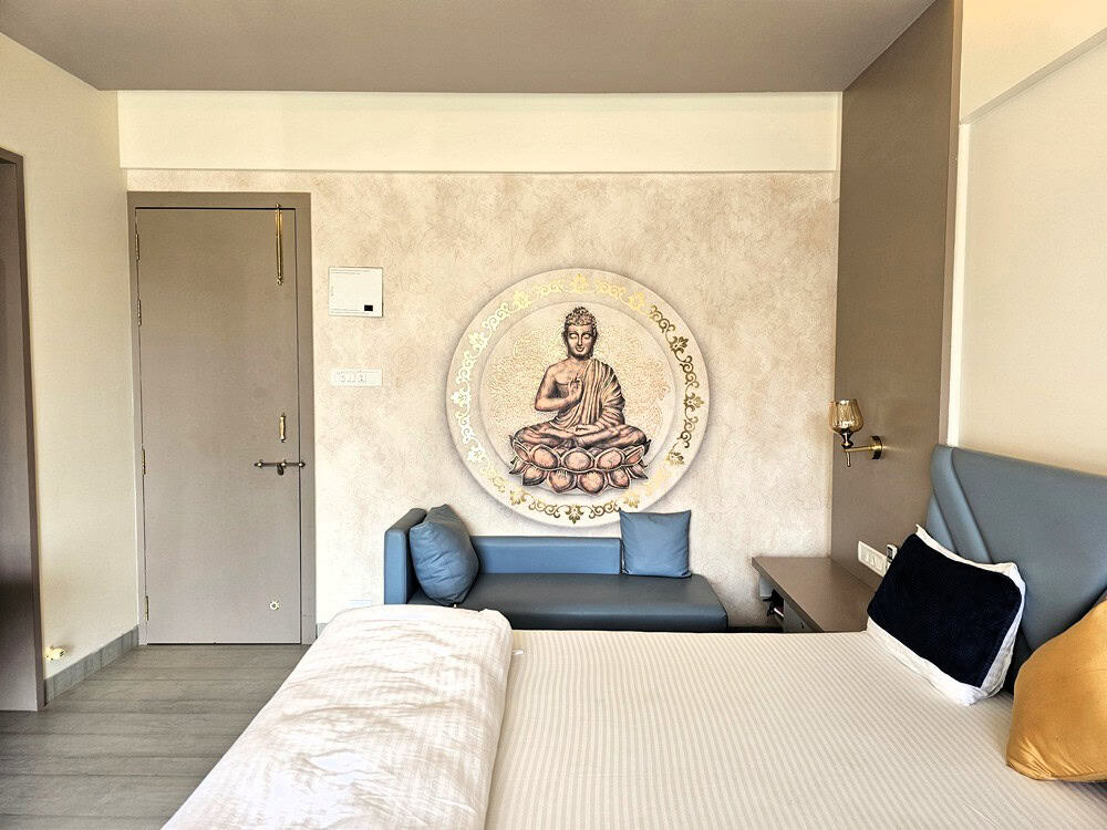 Bedroom with painted Buddha   at Nirvana Naturopathy Retreat & Hospital 