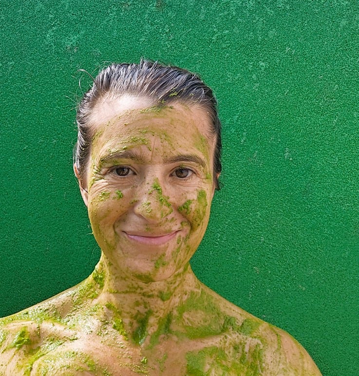 Jenny covered in bright green neem at Nirvana Naturopathy Retreat