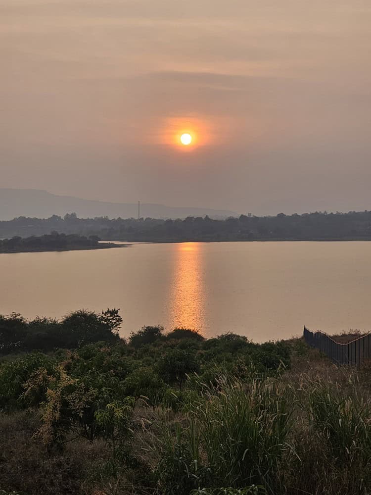 a sunset over the lake at at Nirvana Naturopathy Retreat and Hospital