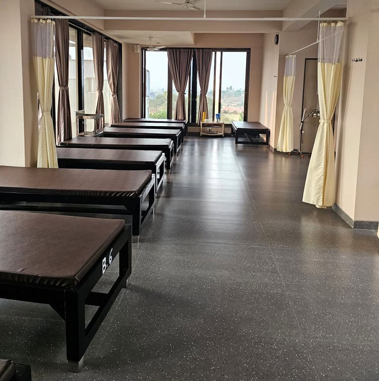 Image shows several beds lined up to show the functionality of space at Nirvana Naturopathy Retreat