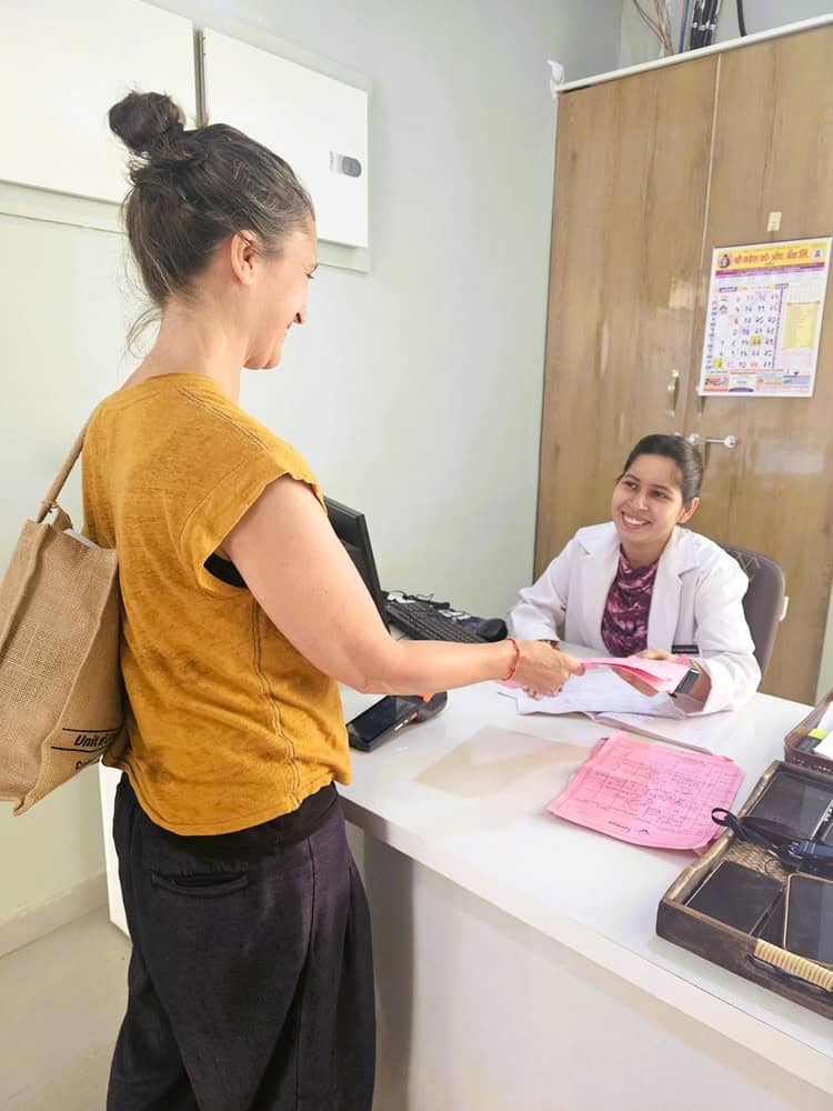 Jenny giving treatment schedule to a doctor  at Nirvana Naturopathy Retreat & Hospital 