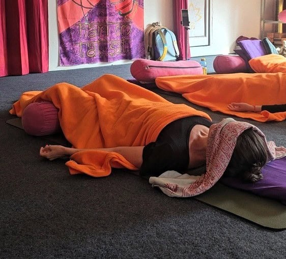 Myself laying on the ground with a blanket over me - at Yoganga Healing Retreat, Rishikesh, India 