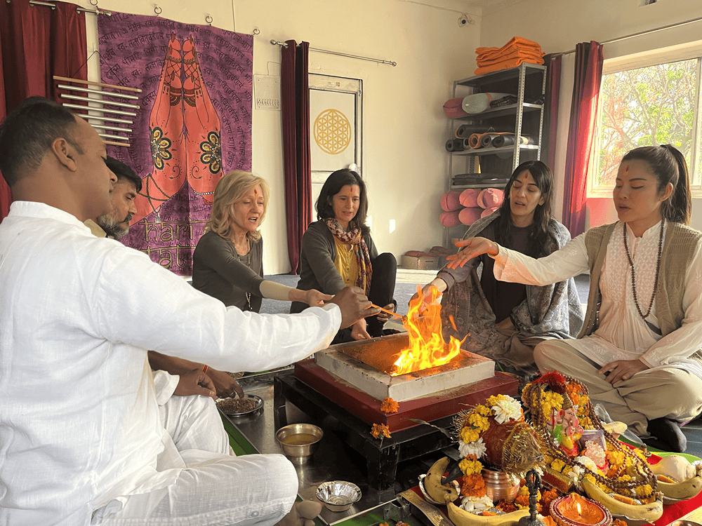 The four participants at Yoganga Healing Retreat, Rishikesh, India taking part in the fire ritual 