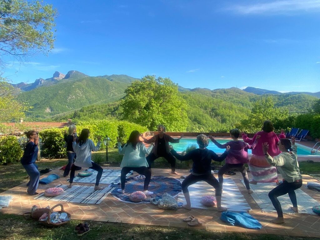 Yoga by the pool at Rosmarino Retreats in Italy 