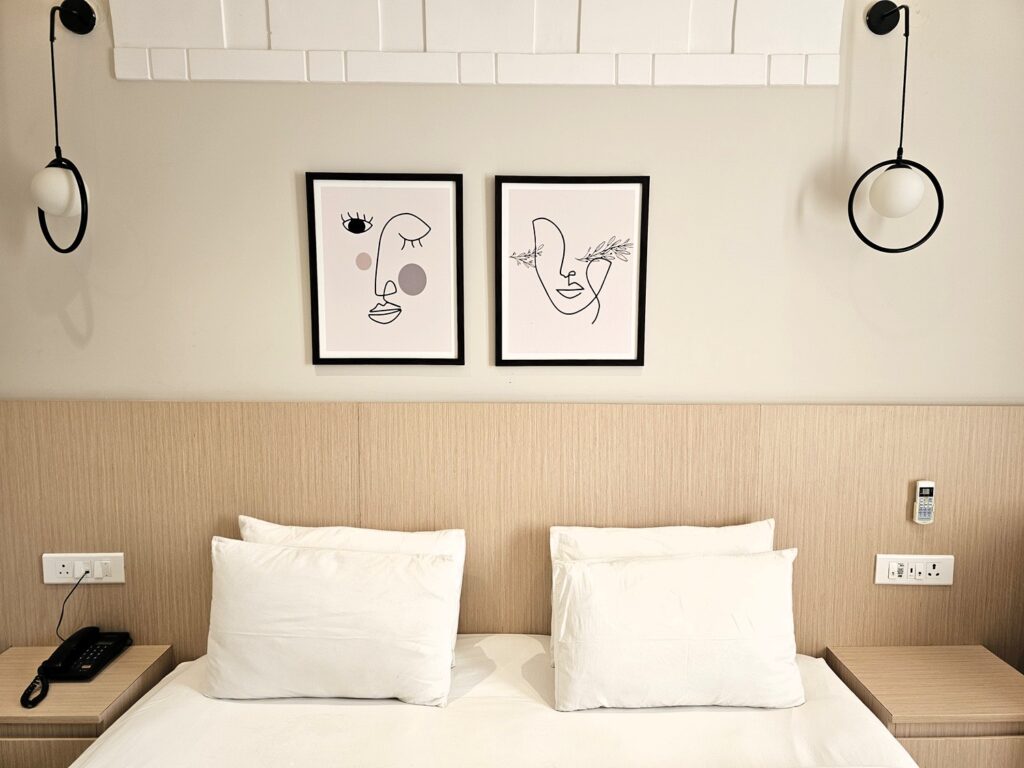 image of simple but stylish artwork above bed at  Yog Vashisht Hotel 