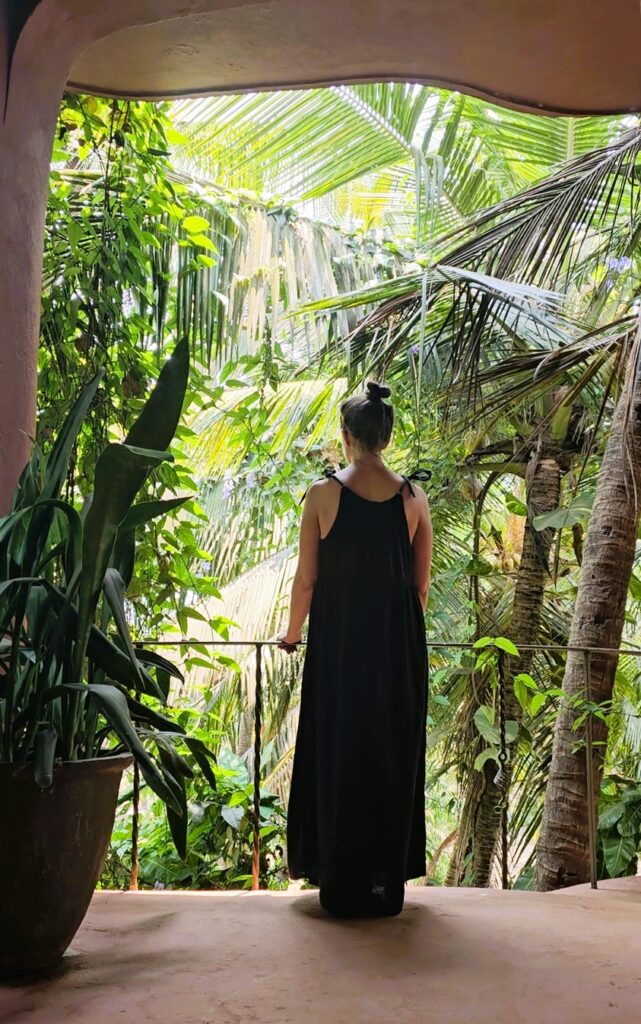 Myself standing and looking outwards over trees at Ashiyana Yoga Retreat in Goa, India 