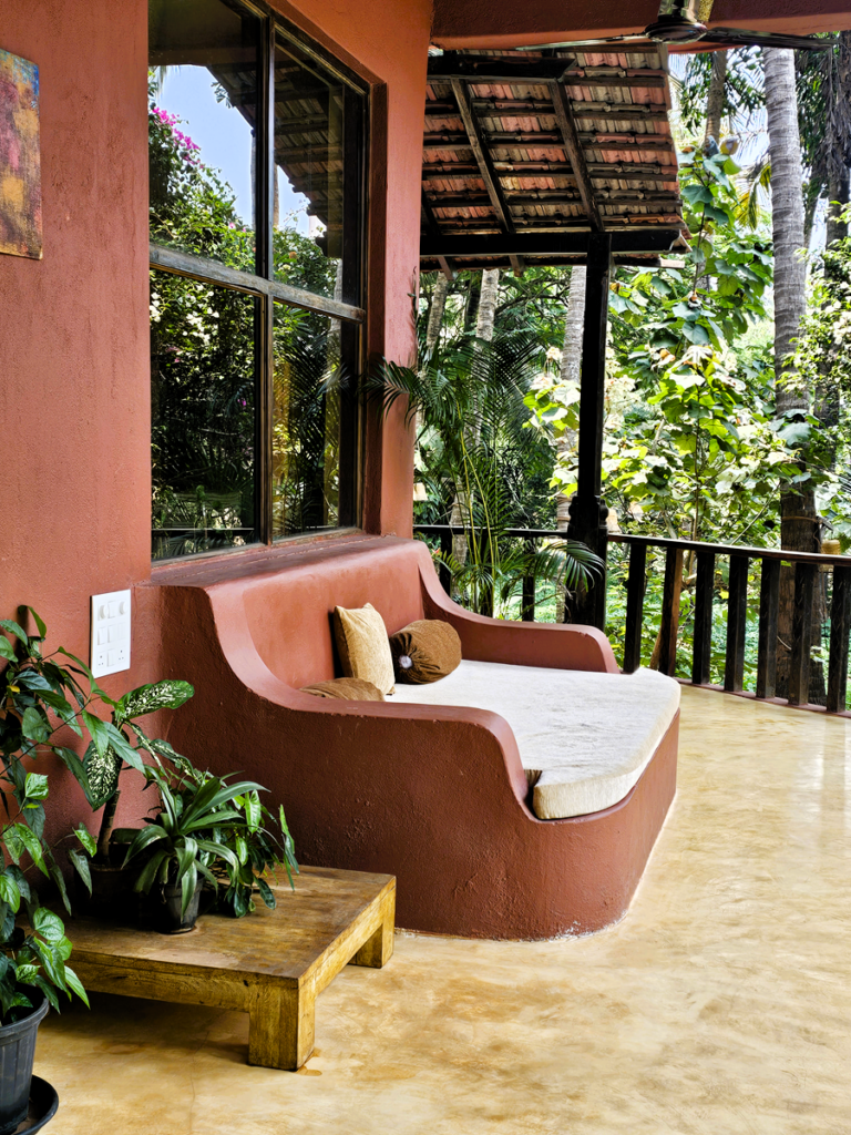 an earthen coloured lounging space with cushions at Ashiyana Yoga Retreat in Goa, India 