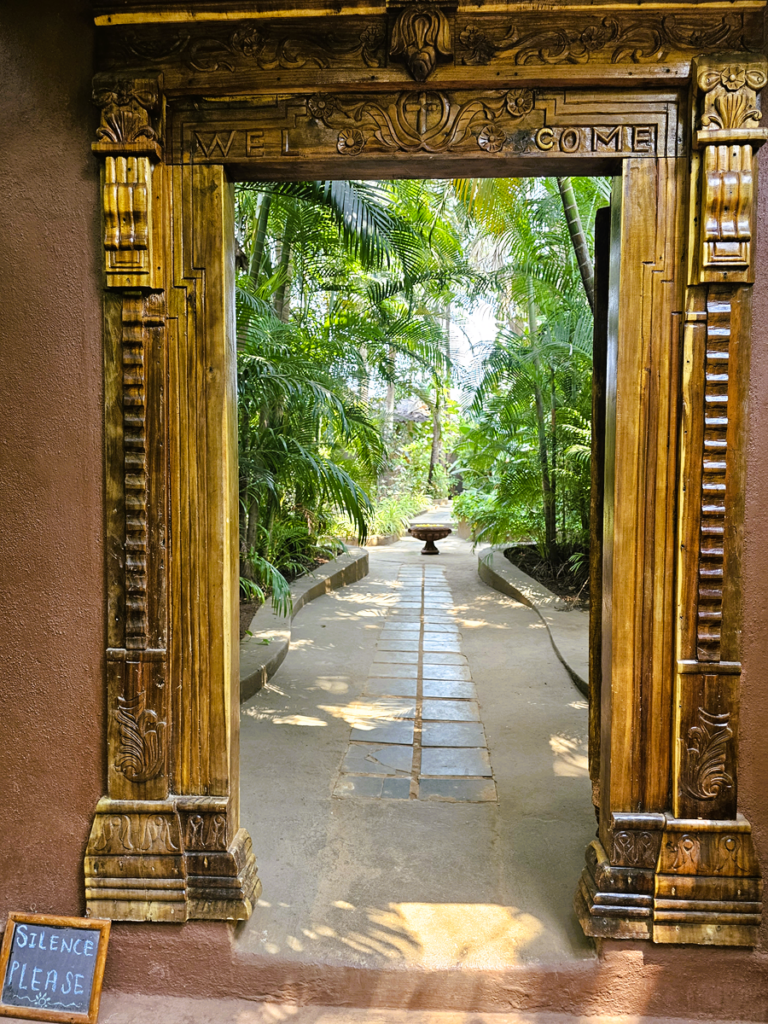 framed doorway at Ashiyana Yoga Retreat, Goa, India with sign saying Silence Please 
