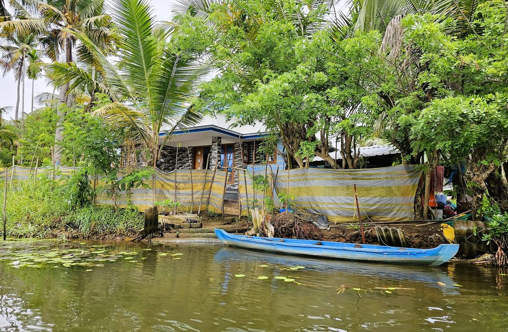 a house next to the backwaters with a small boat
