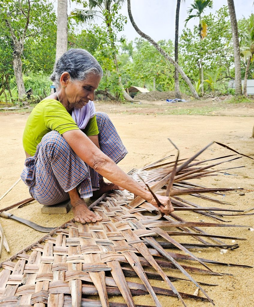 shows woman weaving palm on eco backwaters cruise in Kerala