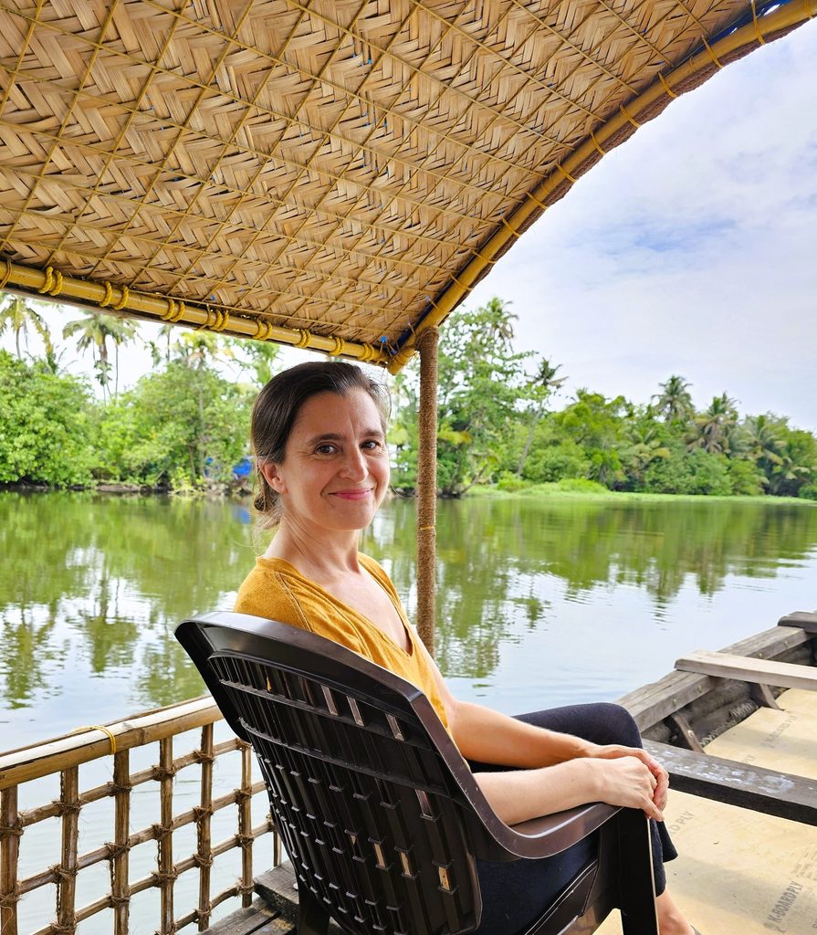 myself sitting at the front of the eco boat smiling, surrounded by the backwaters