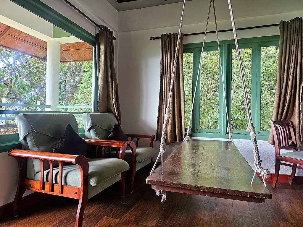two chairs and a wooden swing Blackberry Hills in Munnar