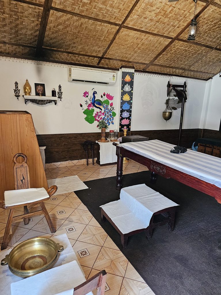 shows massage couch, small seat with a bowl for washing feet at Veda5 Goa 