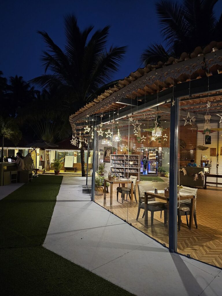 glass windows into the dining room at night at Veda5 Goa 