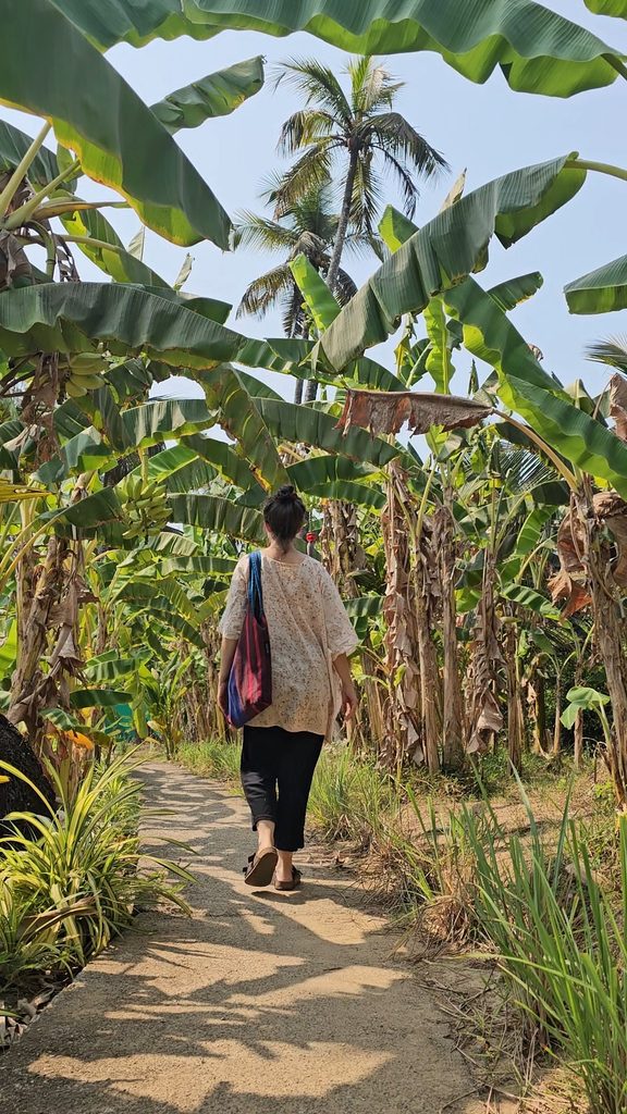 myself walking along the path at Veda5 through banana leaves