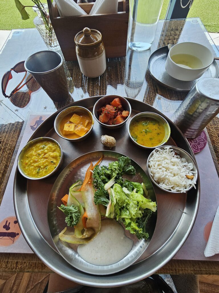 my tray of food - plate with salad, and five bowls containing different dhals, paneer and vegetables