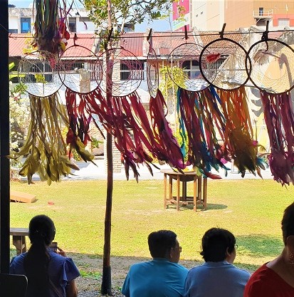 Outside at Hin Bus Depot - a row of dream catchers sway in the wind.