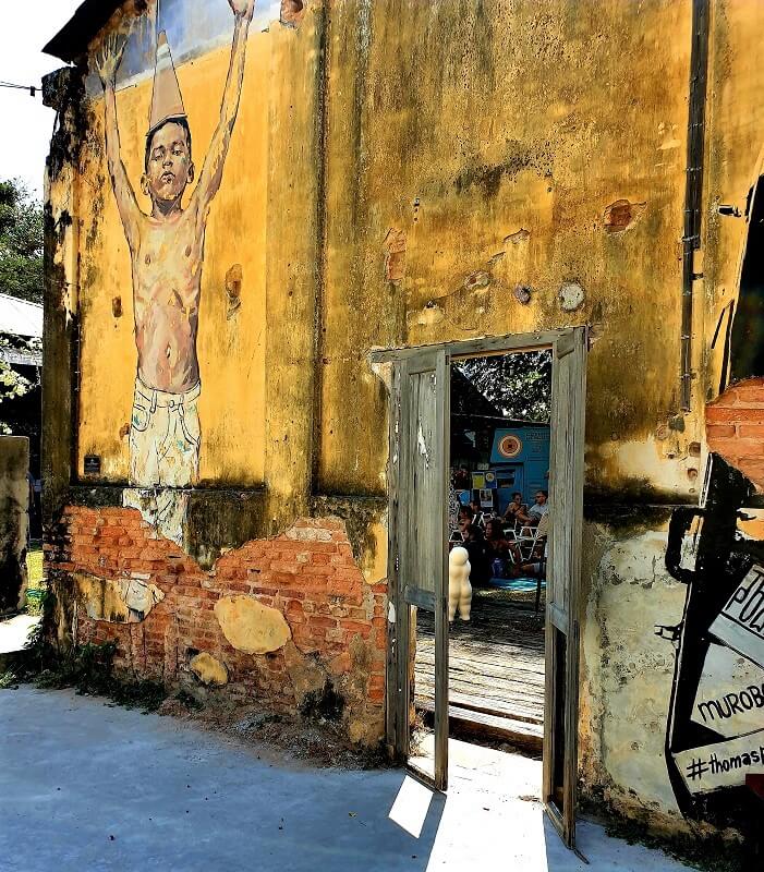 A mural depicting a boy with outstretched arms at Hin Bus Depot.