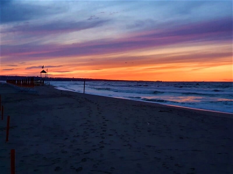 A Molise beach at sunset - vibrant oranges, lavender and yellow