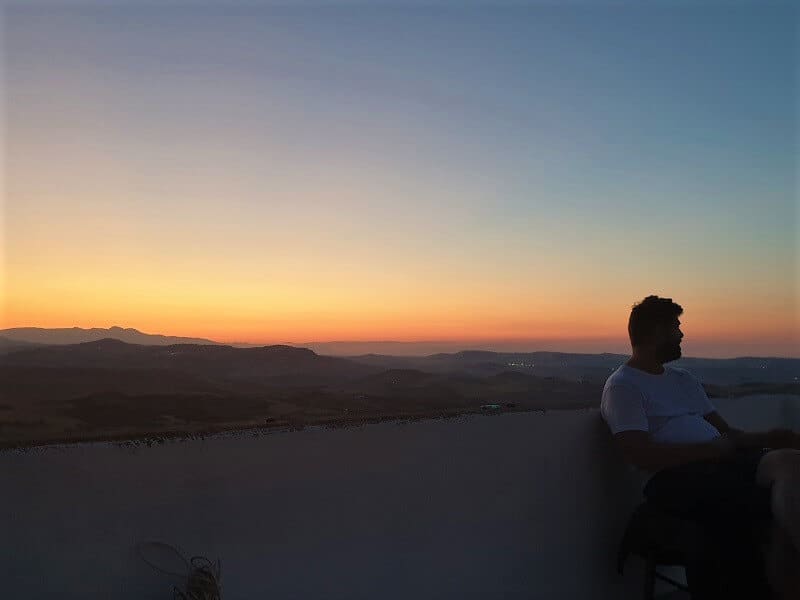 Scott sat on the roof terrace at sunset