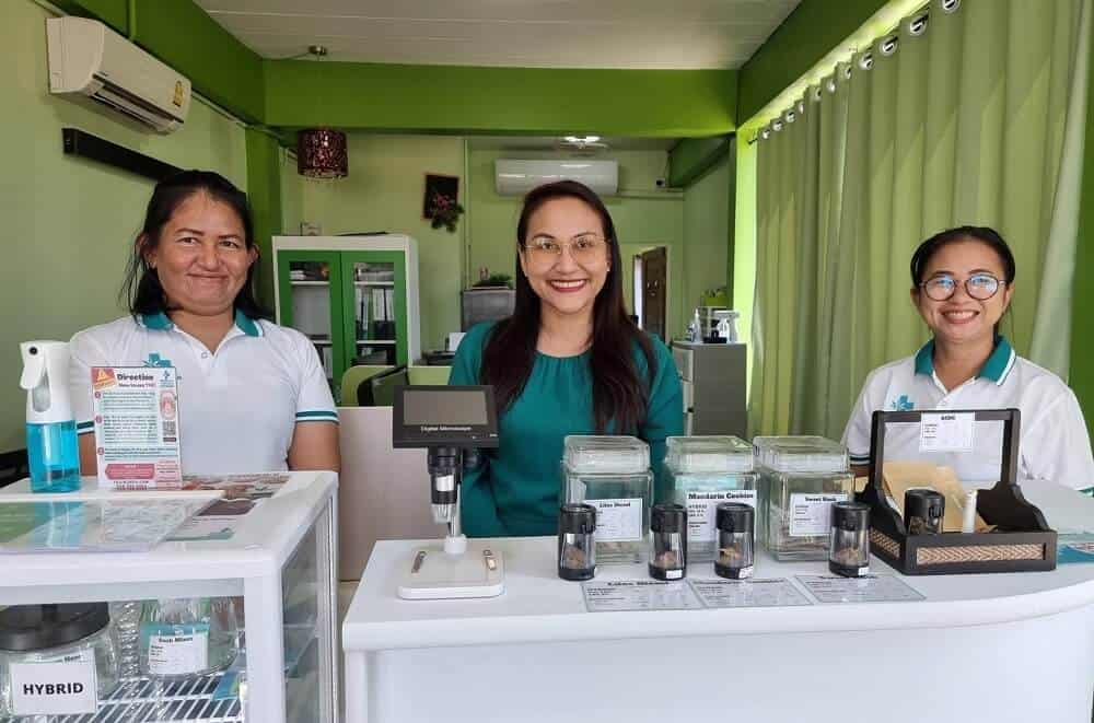 Staff standing in front of jars of cannabis at their shop Medicinal Cannabis 