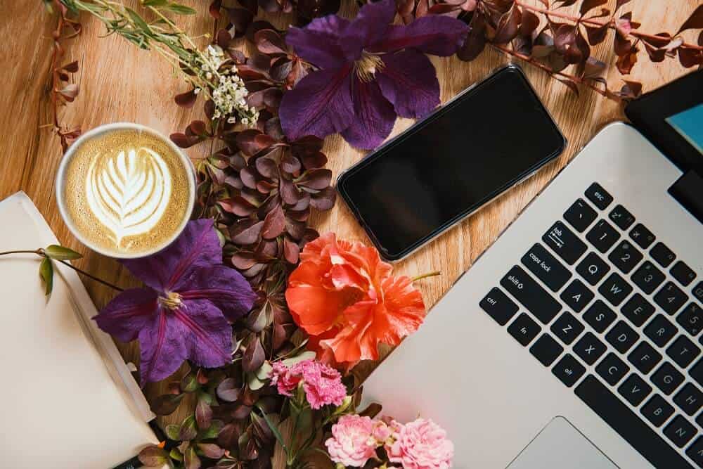 Laptop, flowers, coffee, phone 