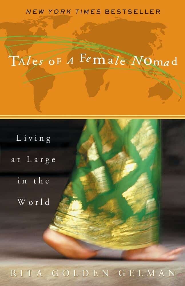 Image of the book titled tales of a female nomad. A quarter of book is orange with a map of the world and the bottom is of a woman's legs in a saree