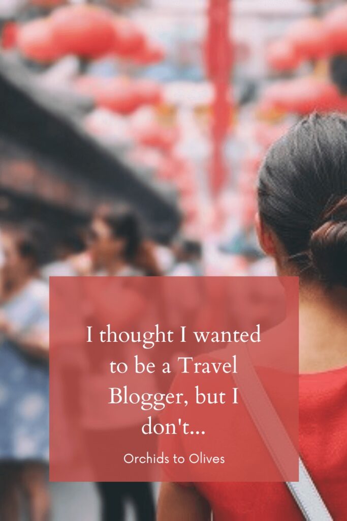 Image of woman from behind, with red lanterns above with the text I thought I wanted to be a Travel Blogger, but I don't....